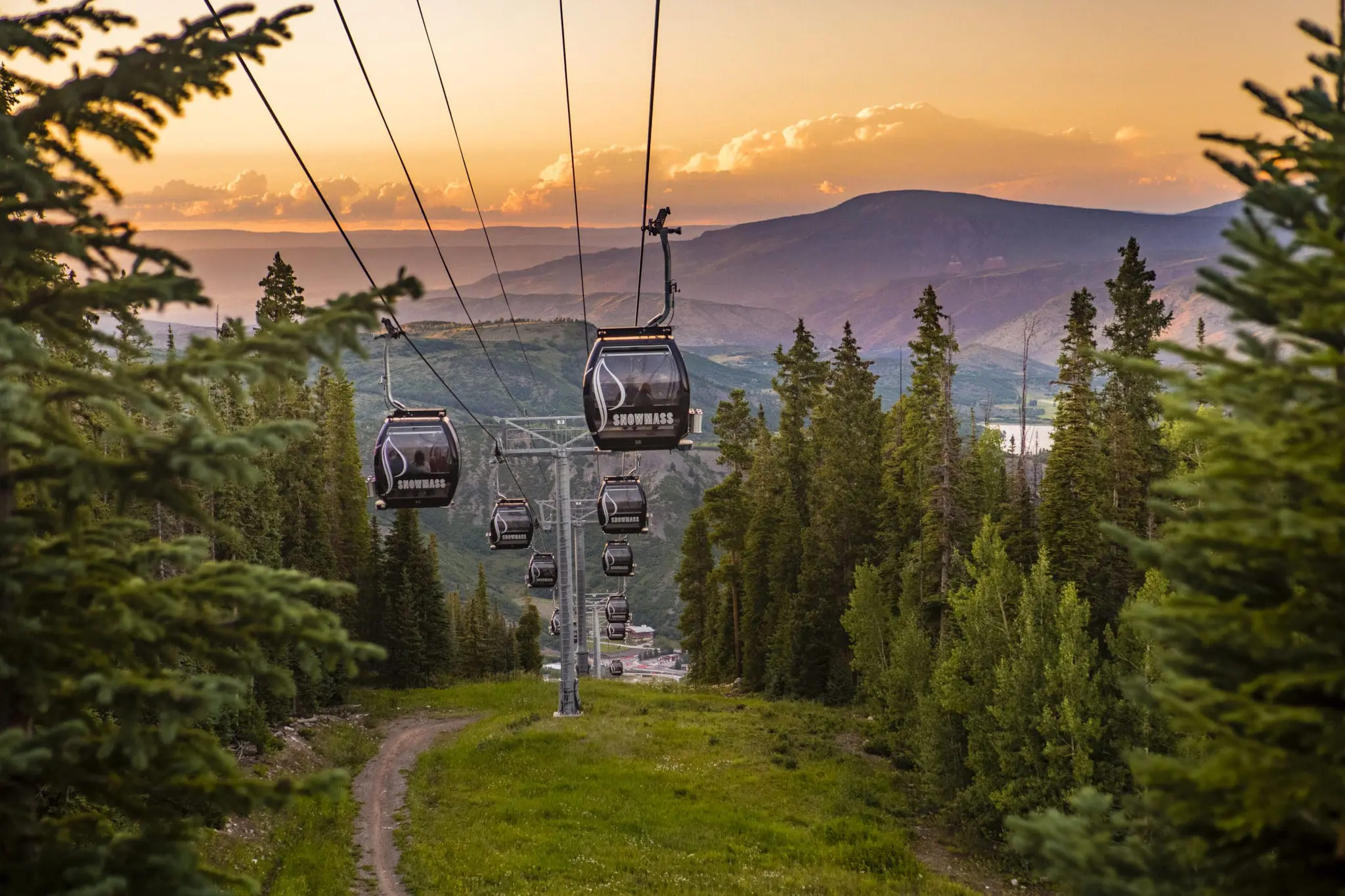Gondolas descending with sunset behind in Snowmass