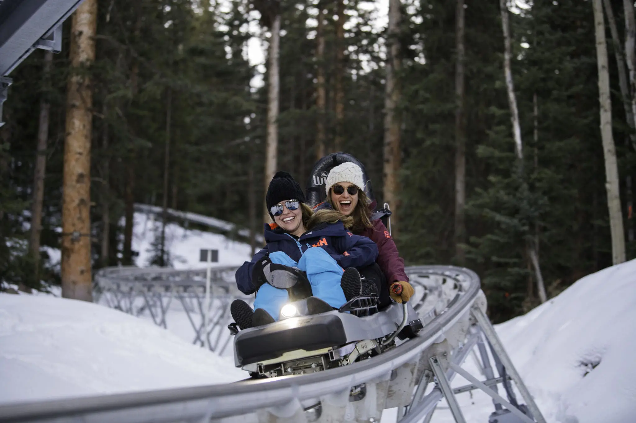 Girls riding down the Snowmass alpine coaster