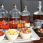 four different whiskeys with four different appetizers