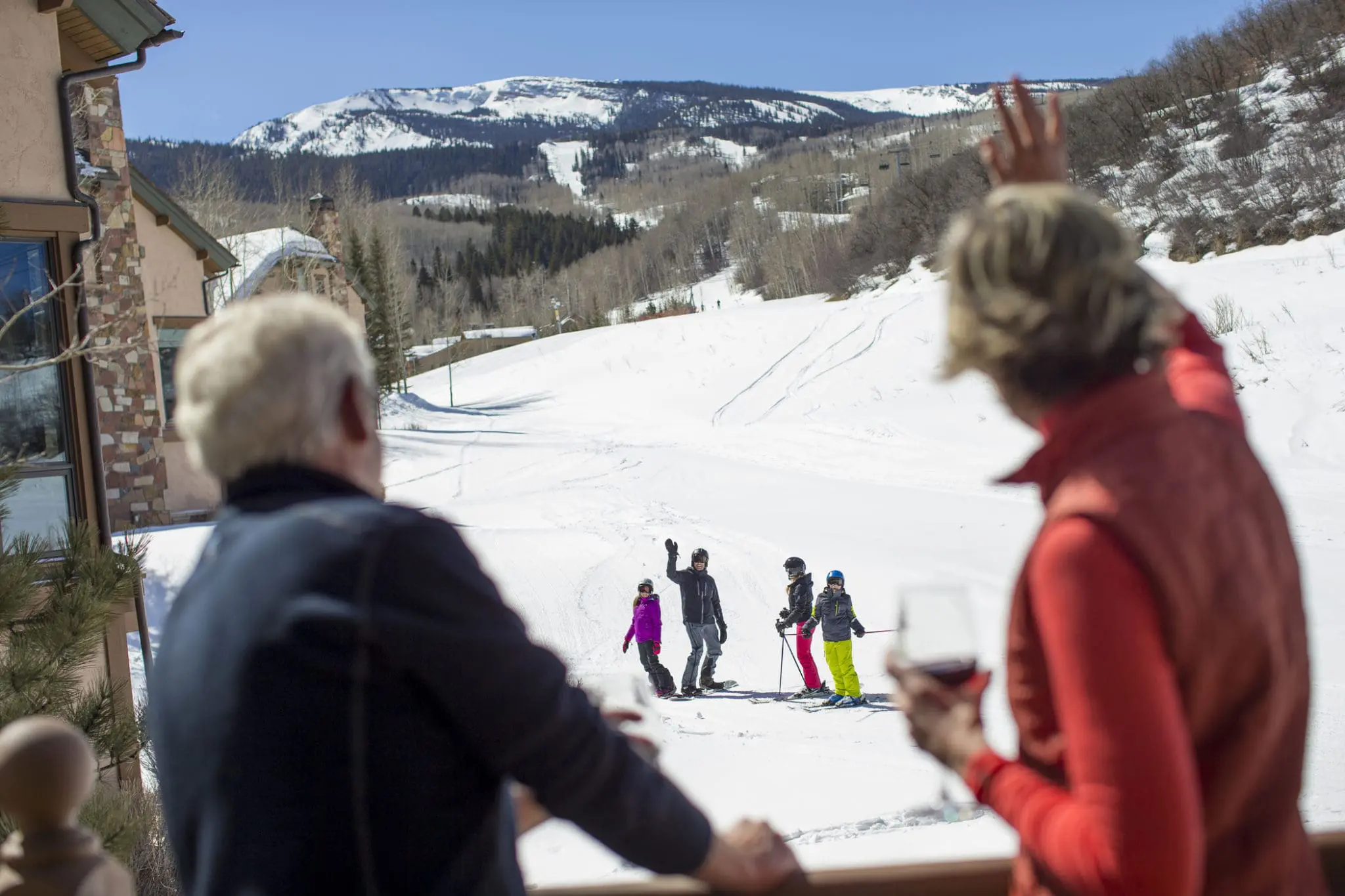 family waves to grandparents from the ski slopes in Snowmass