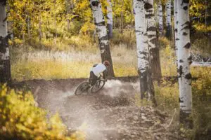 Downhill MTN biker slashing berm