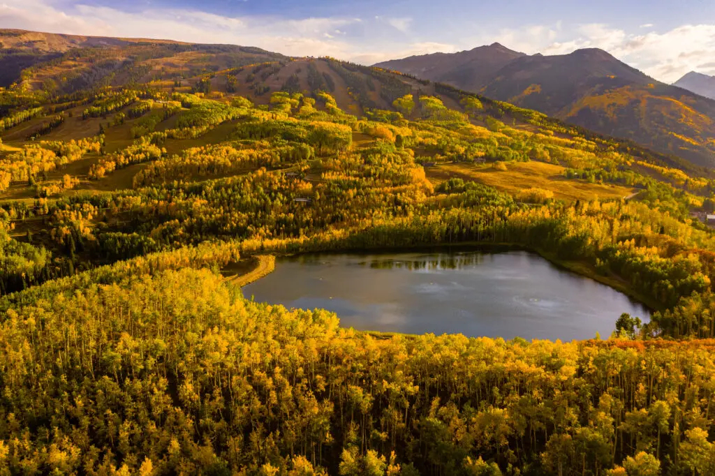 View of Ziegler Reservoir in Snowmass Village in peak autumn foliage.