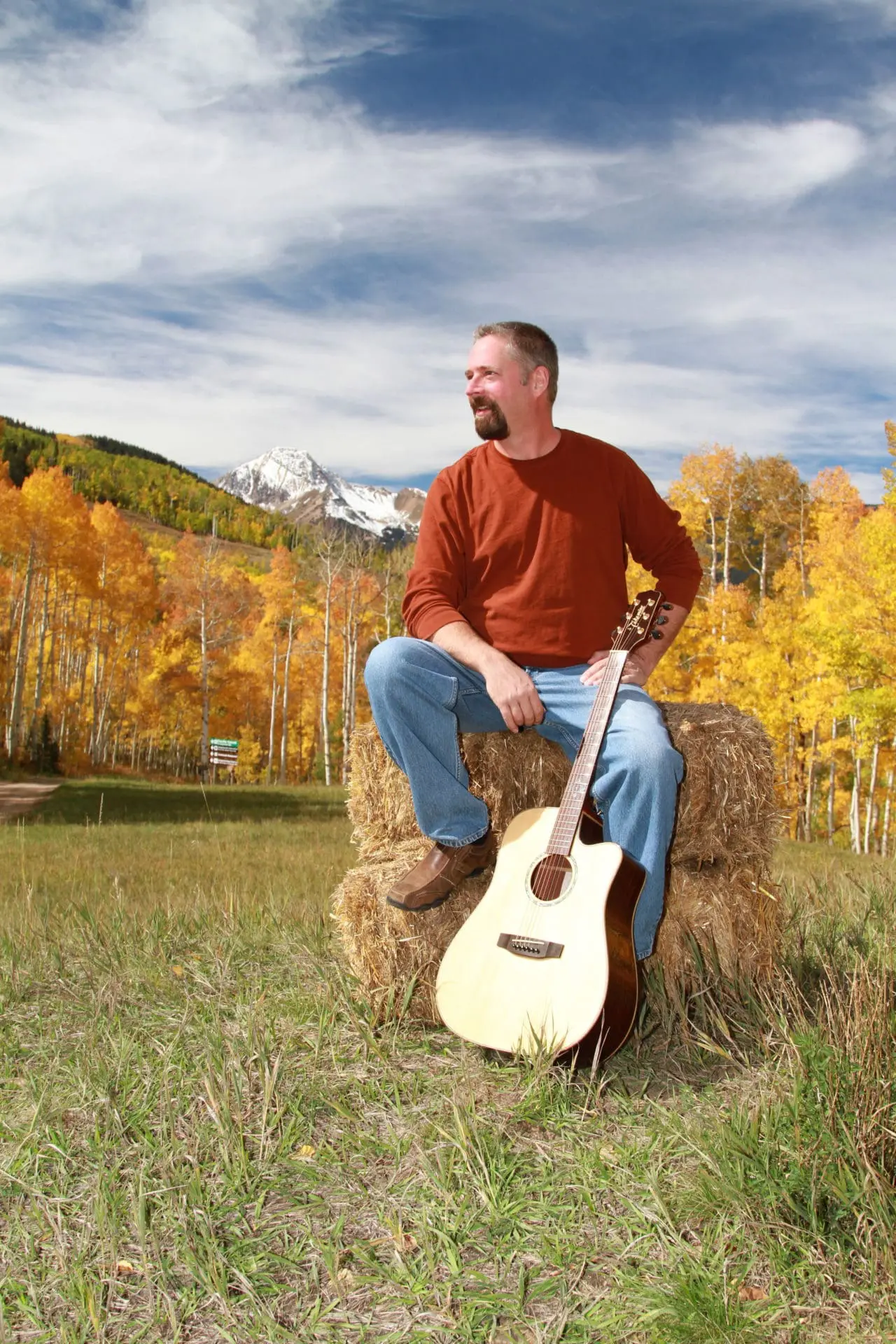 Damian Smith outside with guitar
