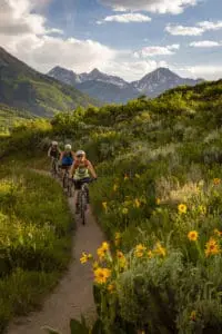 A group of friends biking a trail