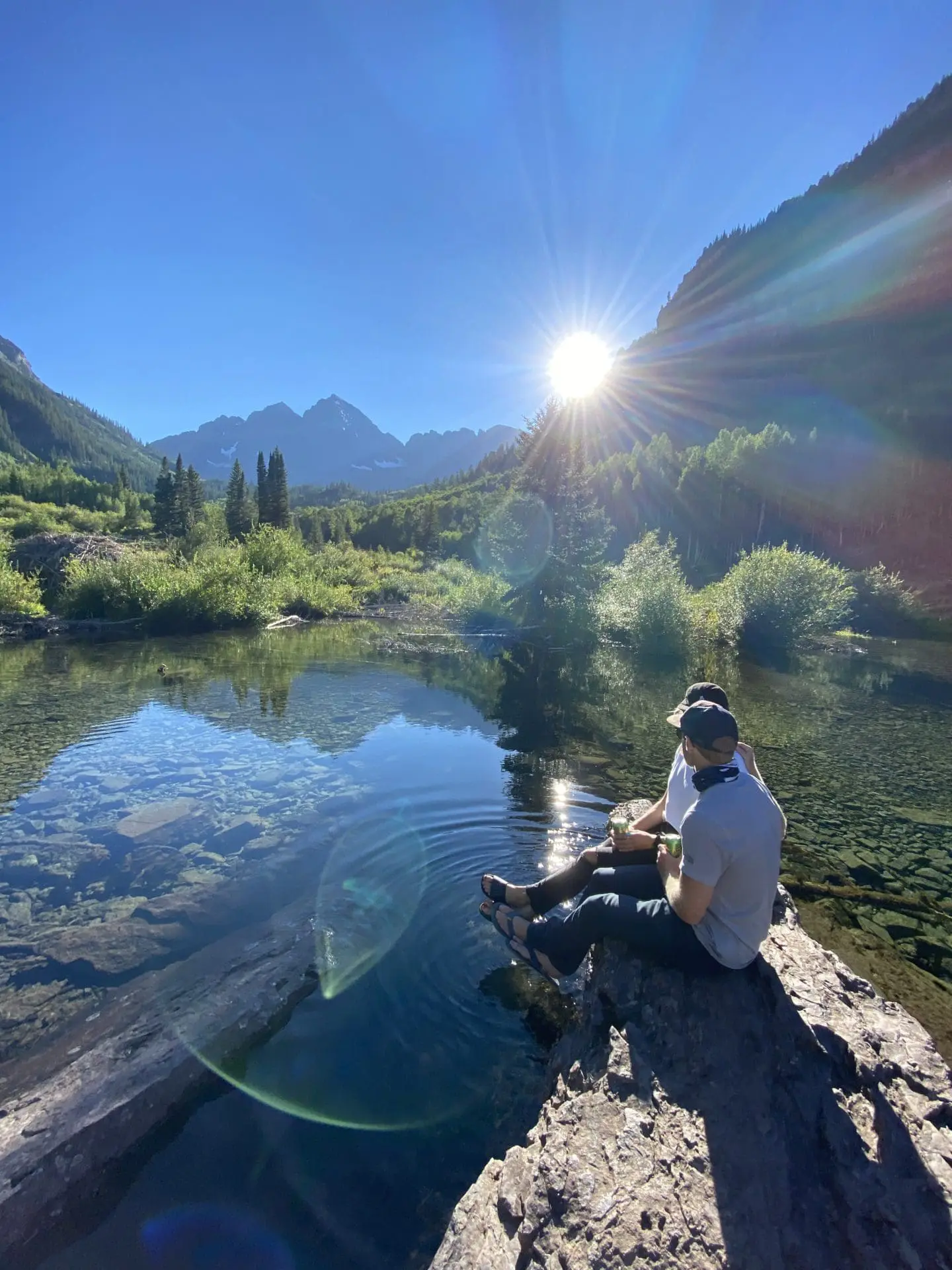People hanging outside by a lake
