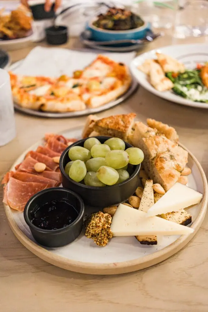 plate of meat, cheese and fruit