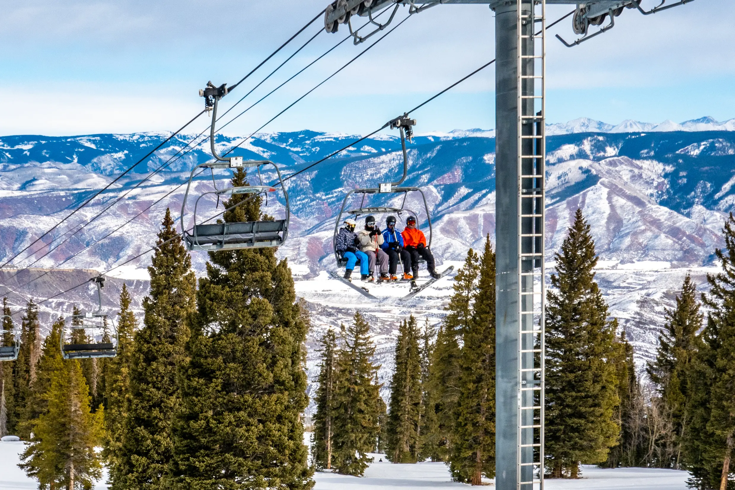 skiers on the chairlifts at Snowmass