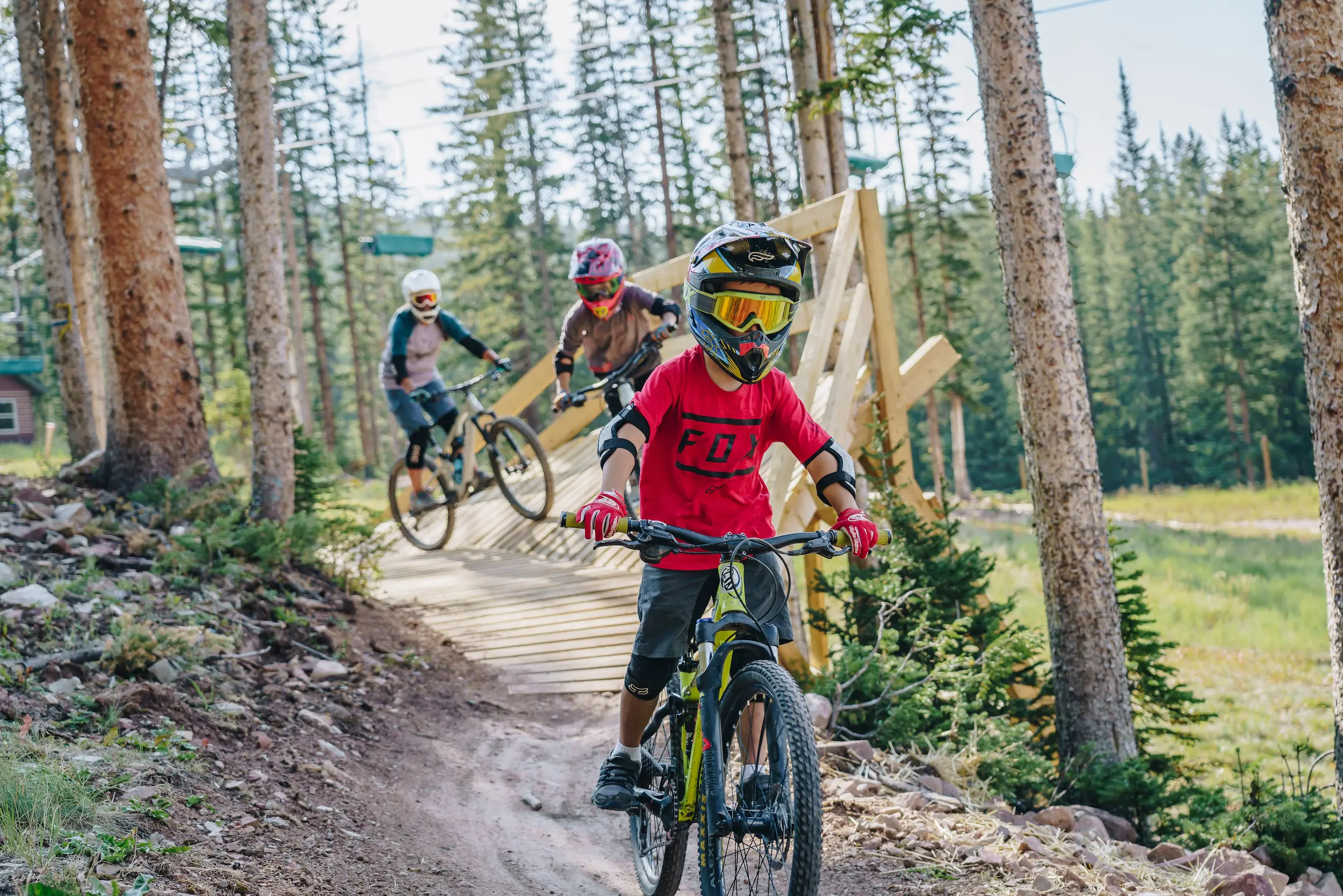 children riding bikes down a path during their summer Colorado family vacation