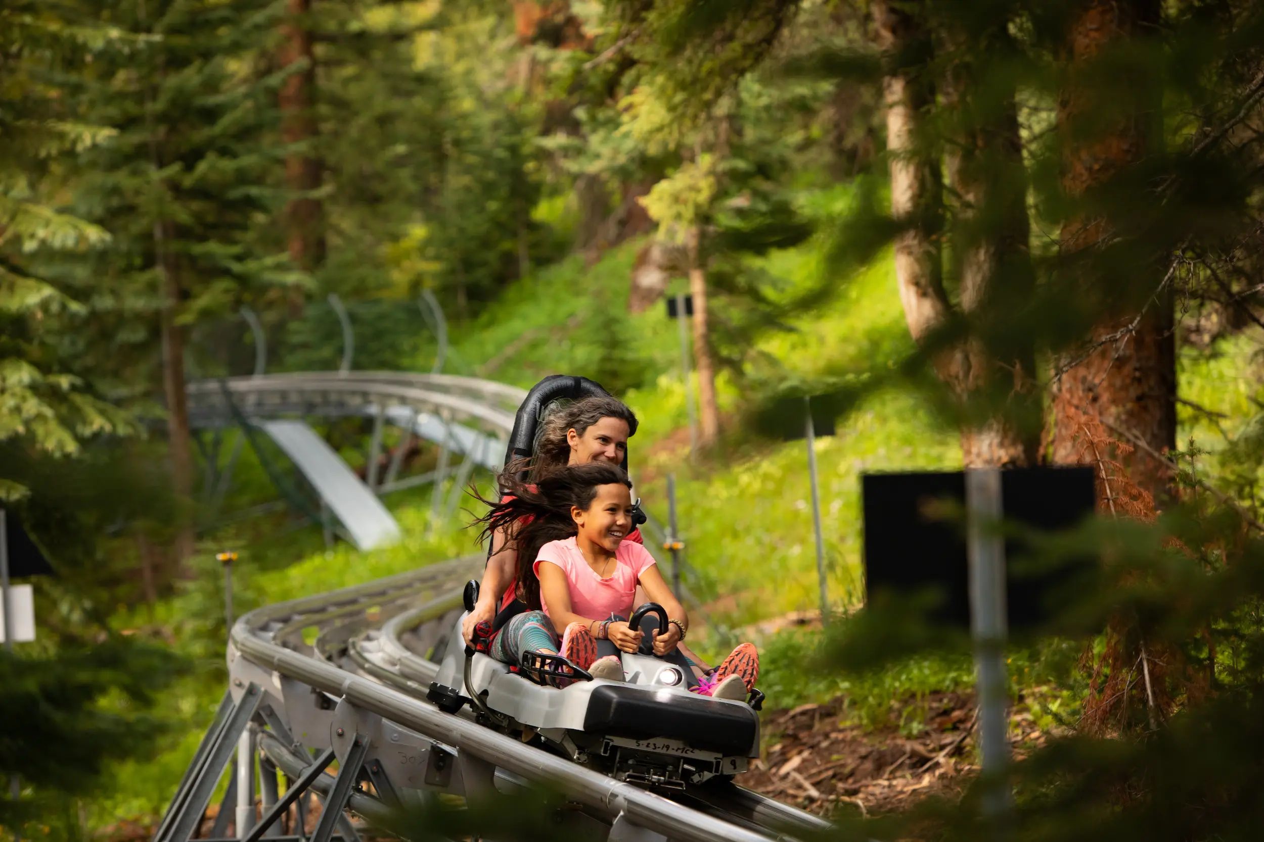 mother and daughter on the Breathtaker roller coaster during their Colorado family summer vacation