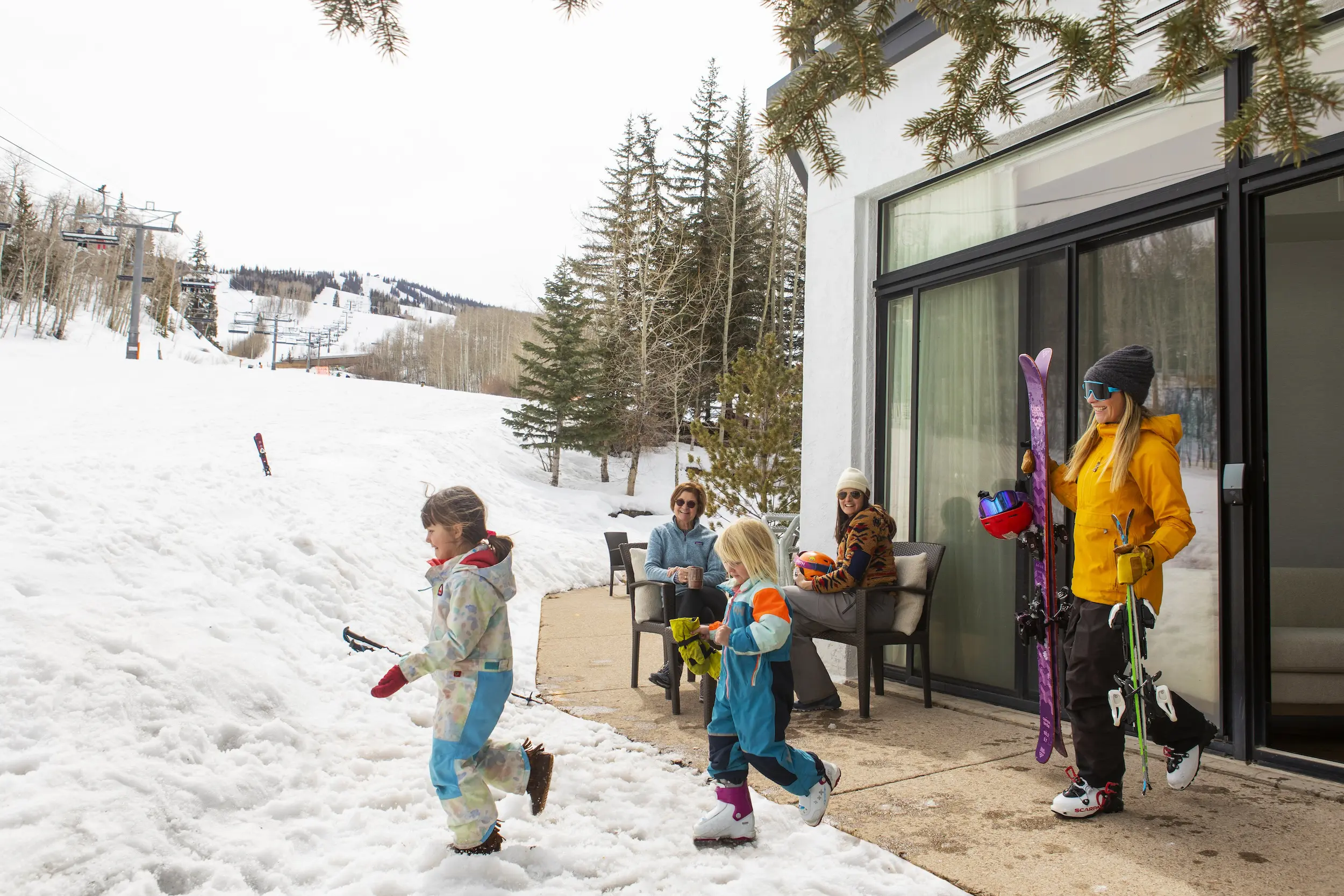 children running out of their hotel room to the ski slopes during their winter Colorado family vacation