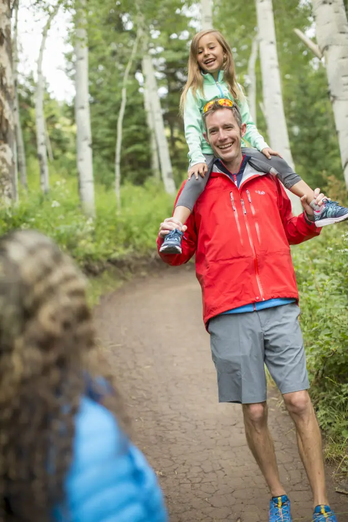 a dad on a hiking trail in snowmass with toddler