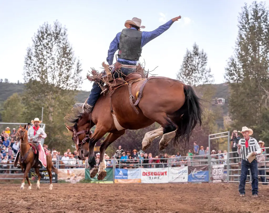 man riding a horse during a rodeo in Snowmass