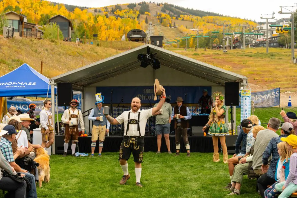 man standing with a beer in his hand during the fall Oktoberfest near Aspen Colorado