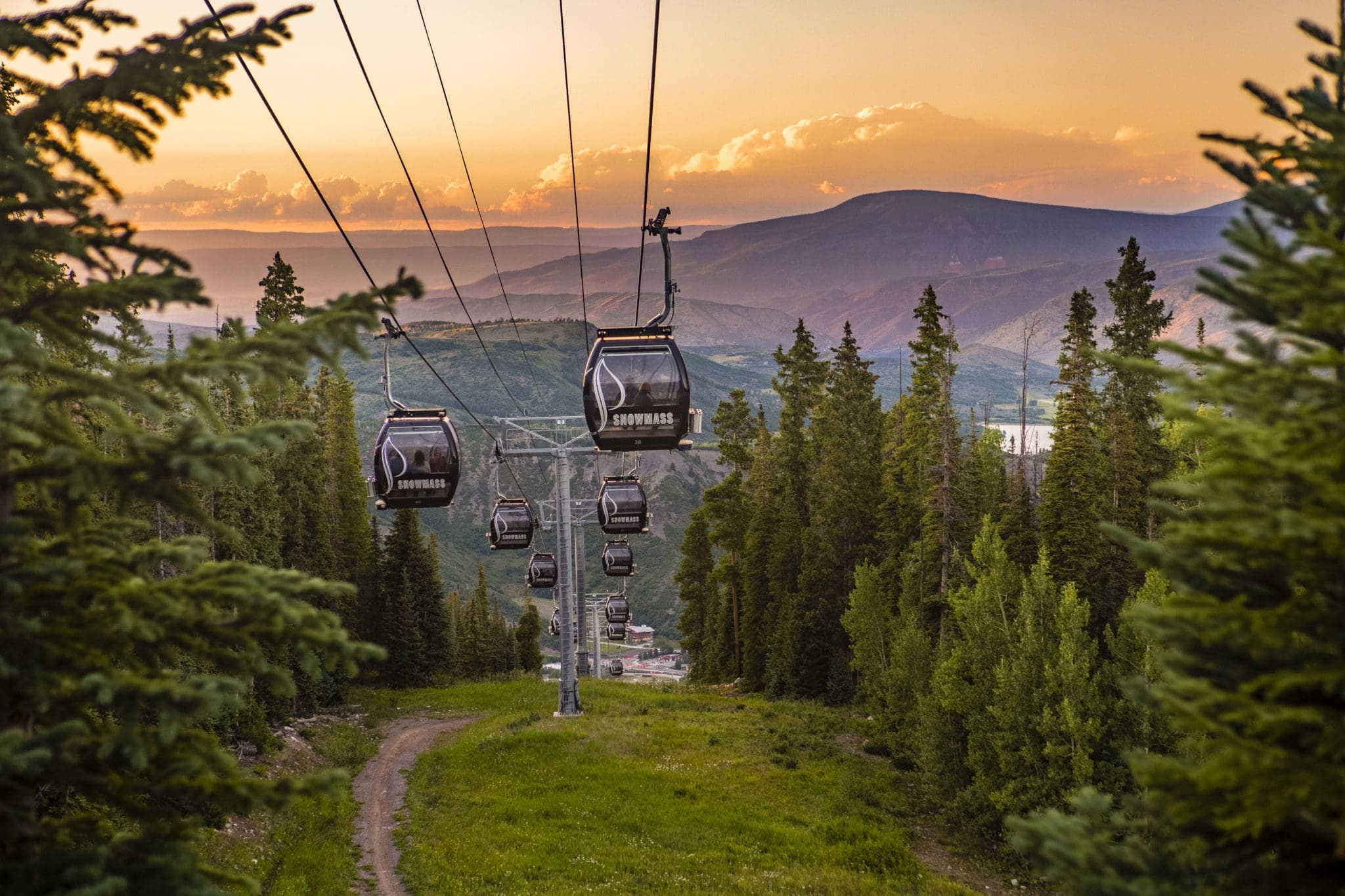 Gondolas descending with sunset behind in Snowmass
