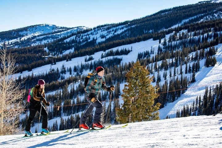 People uphill skiing