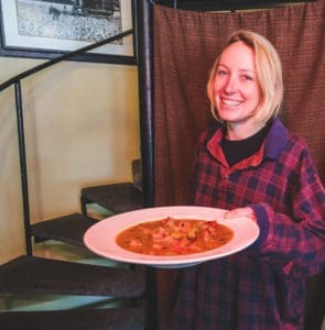 Woman holding bowl of stew