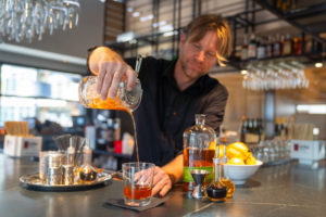 A drink being poured by a bartender