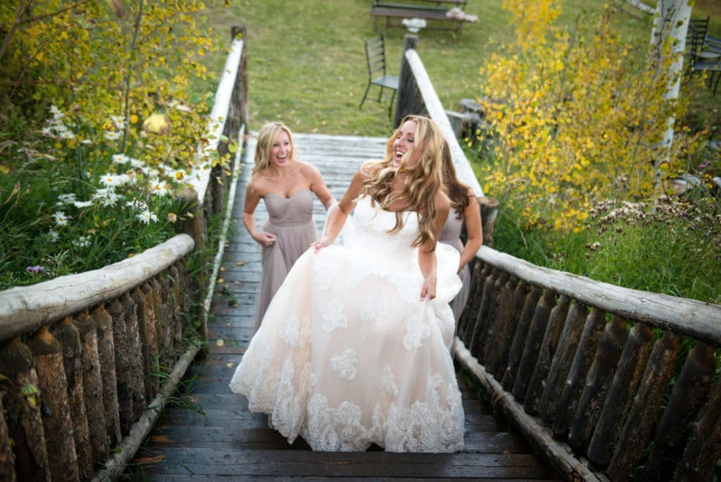 A bride walking upstairs laughing