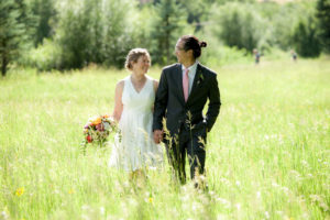Wedding couple walking in tall grass