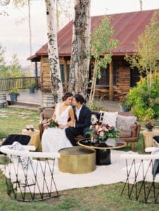 A couple together in front of tree