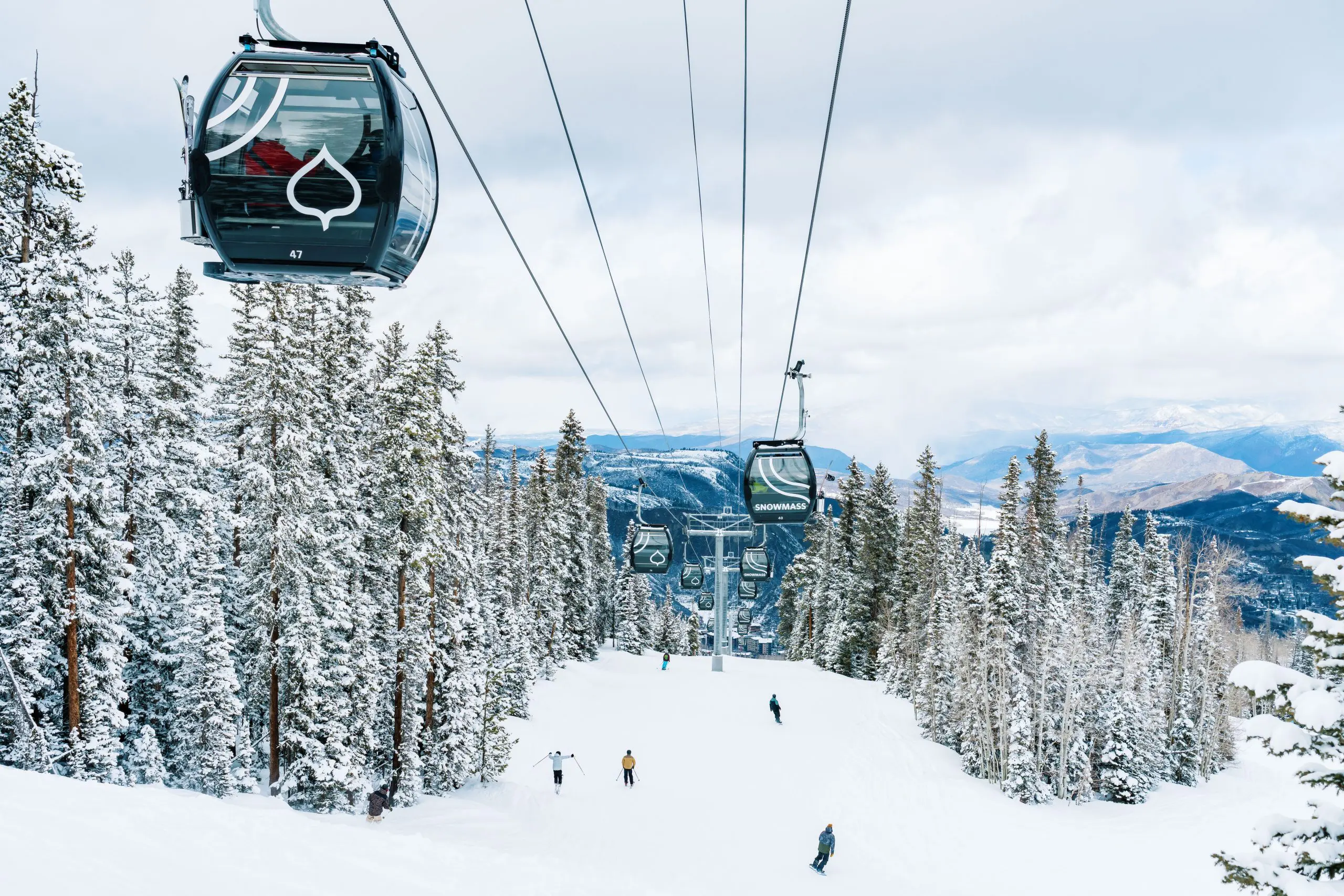 elk camp gondola being used by first time and beginner skiers going up the mountain to learn how to ski