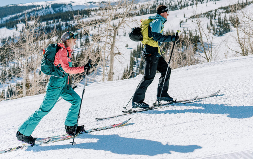 Two skiers in bright colors uphill to breakfast during 3 days in Snowmass.