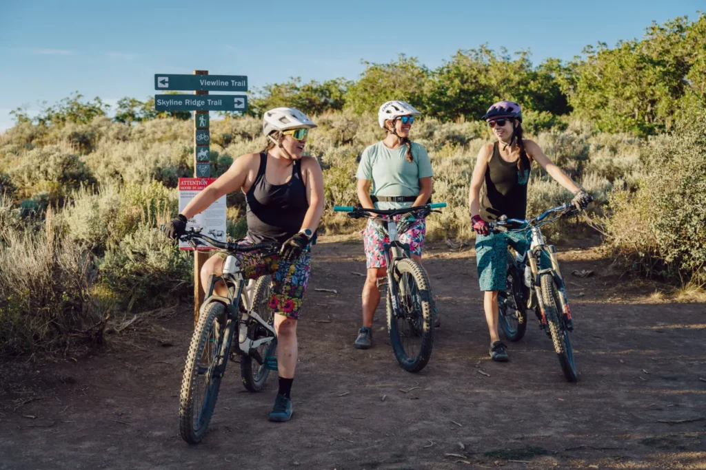 three women on a mountain biking trail attraction near Aspen Colorado during their summer travels