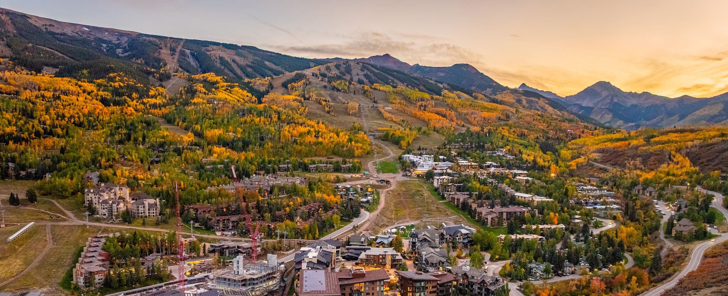 aerial view of lodging accommodations near Aspen in the autumn as the fall foliage changes color to shades of yellow and orange